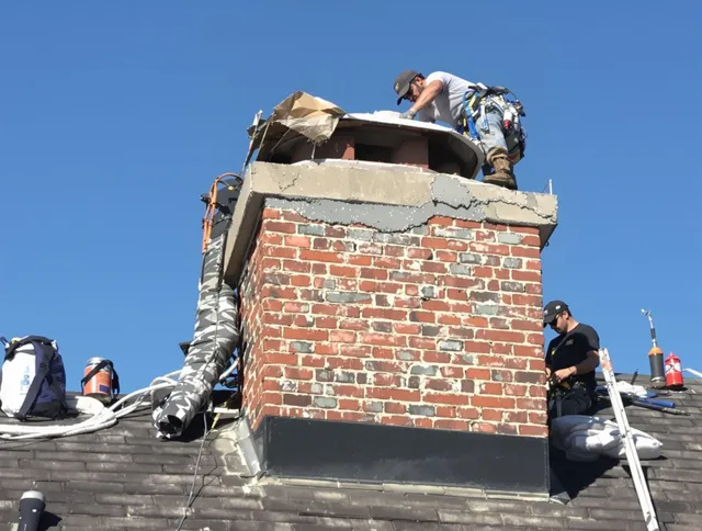 Hull Chimney Sweep installing a custom chimney crown in Hull, MA